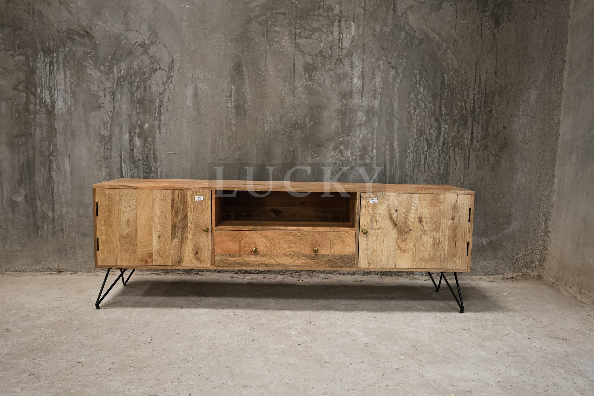 Mango wood tv stand with brass inlay and hair pin legs.