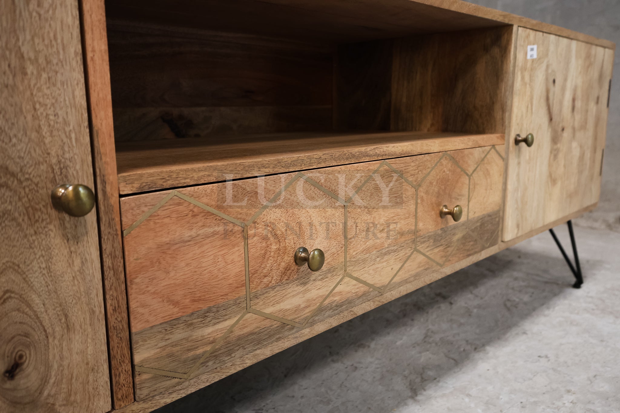 Mango wood tv stand with brass inlay and hair pin legs.