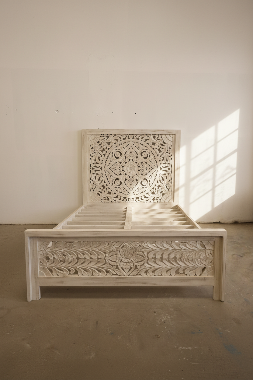 Carved whitewashed wooden bed.