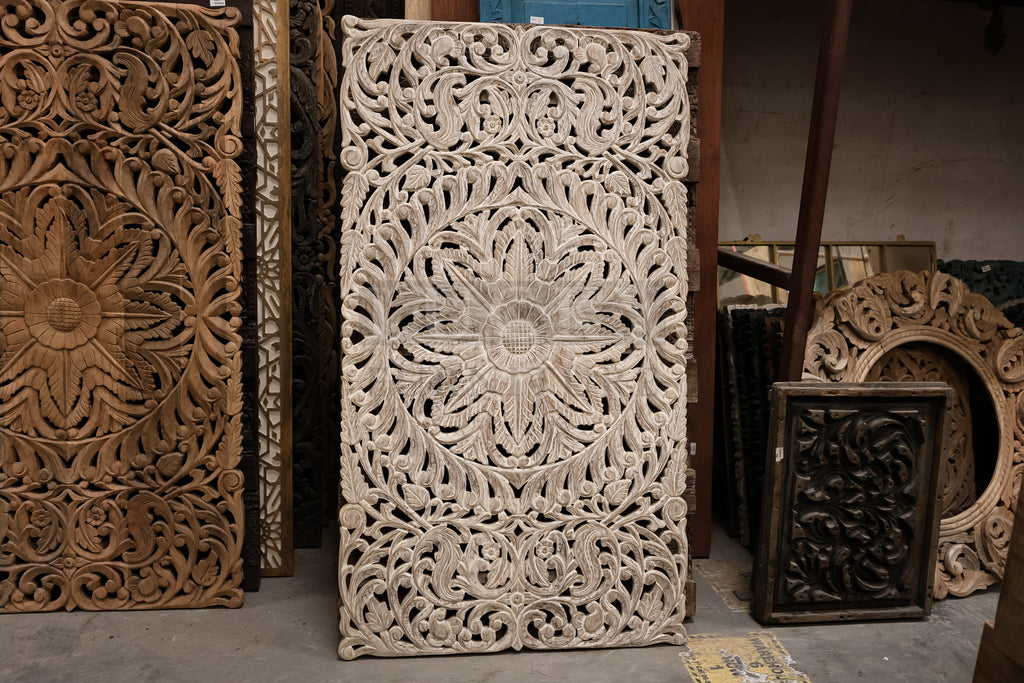 Whitewashed carved wooden panel.