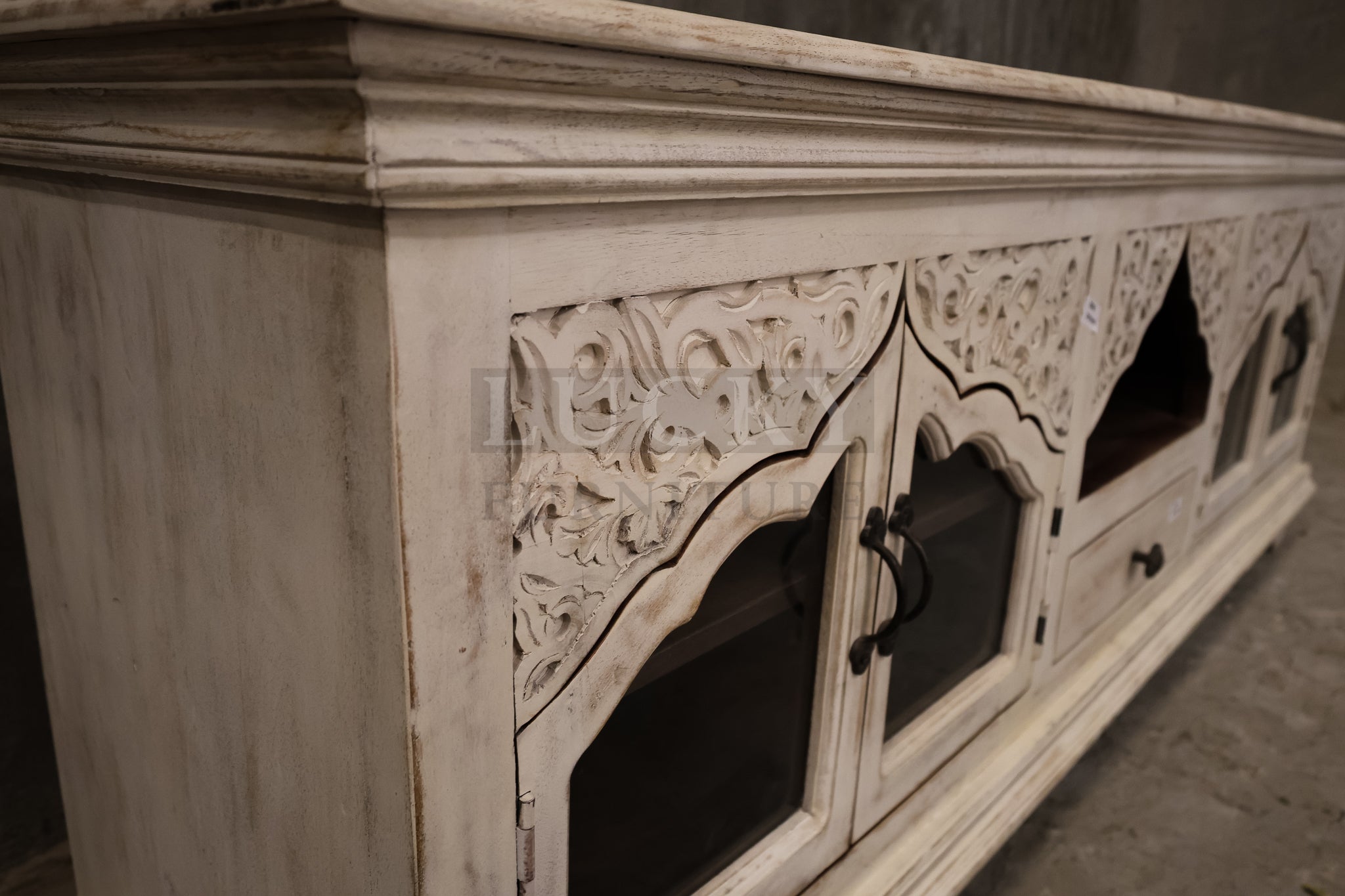 Carved whitewashed tv stand.