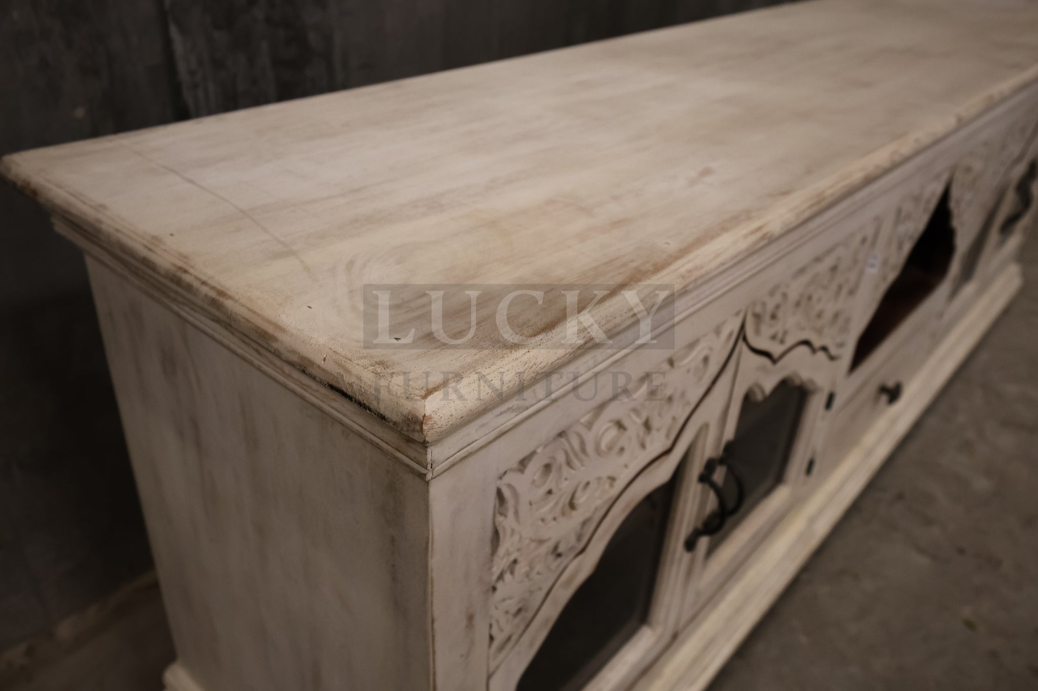 Carved whitewashed tv stand.