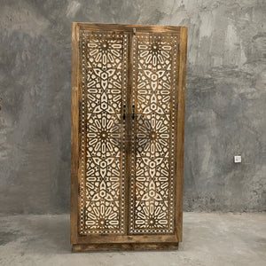 Carved cabinet with white painted inlay.