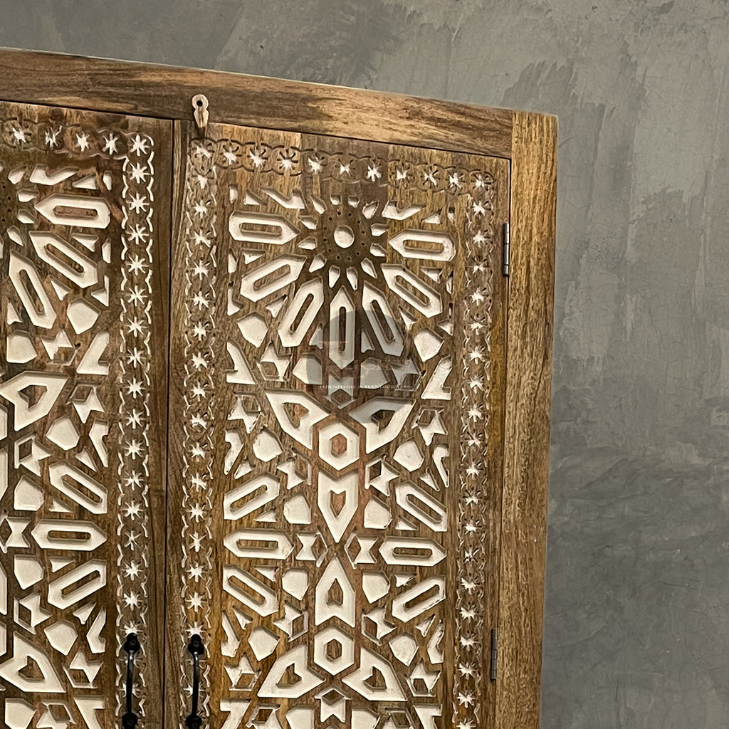 Carved cabinet with white painted inlay.